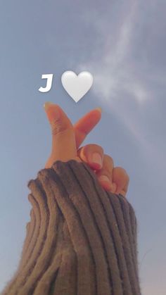 someone holding their hand up to the sky with an i love you message above them