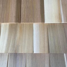 several different types of wood planks arranged on top of each other, including white and brown