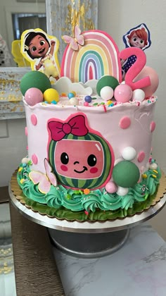 there is a cake decorated with cartoon characters on the top and decorations in the bottom