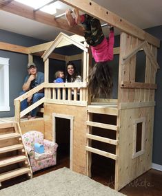 children are playing in a wooden loft bed