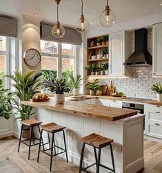 a kitchen with white cabinets and wooden counter tops next to two stools in front of an island