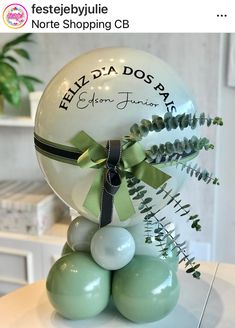 a bunch of balloons that are sitting on top of a table in front of a plant