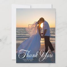 a wedding thank card with an image of a bride and groom kissing on the beach