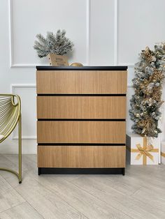 a wooden dresser sitting next to a christmas tree