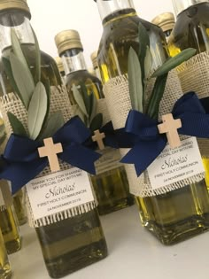 olive oil bottles with crosses and labels on them for baptisms or special occasions to give as favors