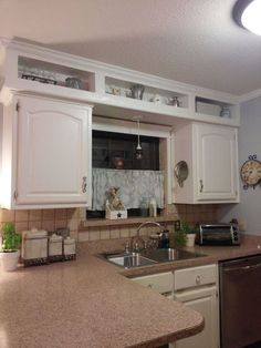 a kitchen with white cabinets and granite counter tops