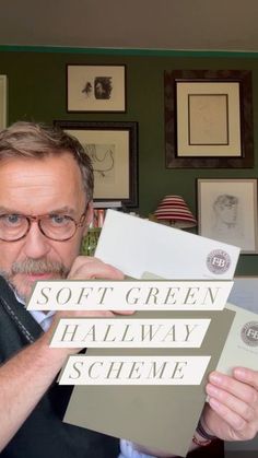 a man holding up some papers in front of his face with the words soft green halfway scheme on it