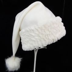 "Novelty Santa hat is made up in a creamy and cozy winter white poly fleece fabric. Hat is styled in the classic Santa slouch cone and is accented with a soft matching faux fur fabric trim with a faux fur pompom on the top. Proportions of the hat are generous and will fit most head sizes, ladies or gents. Measurement for opening for your head is 24-25\" circumference and the length is 20\". Check measurements to make sure this size will work for you. Custom orders depend on fabric availability a White Winter Hat, One Size Fits Most, White Mini Hats For Winter Party, Adjustable Cream Winter Felt Hat, Adjustable White Felt Hat For Winter, White Beanie Costume Hat For Winter, White Brimmed Felt Hat For Winter, White Winter Beanie Costume Hat, White Beanie For Winter Costume, White Beanie For Winter Festival