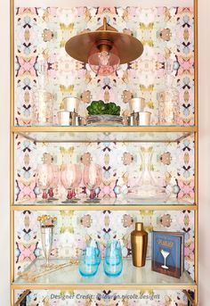 the shelves are decorated with pink and gold wallpaper