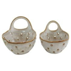 two white dishes with gold dots on them