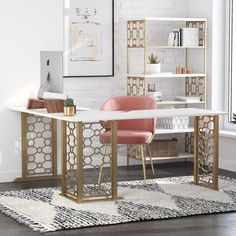 a white desk with gold accents and pink chairs