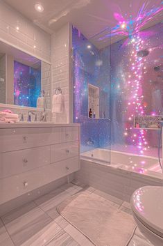 a bathroom with pink and blue lights on the shower wall, sink and bathtub