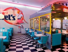 the interior of a diner with blue and yellow booths