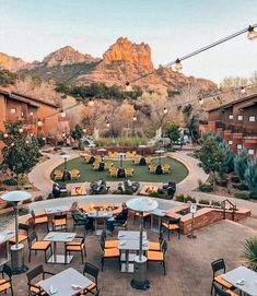 an outdoor dining area with mountains in the background