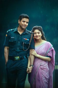 a man and woman standing next to each other in the rain wearing police uniforms, holding hands