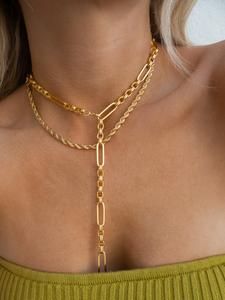 Chic Gold Lariat Necklace With Clavicle Chain, Chic Gold Lariat Jewelry, Chic Lariat Chain Necklace, Gold Elegant Lariat Necklace, Formal Lariat Chain Jewelry, Gold Dangle Chain Necklace For Layering, Gold-tone Jewelry With Figaro Chain, Formal Gold Lariat Necklace With Clavicle Chain, Gold Lariat Necklace With Clavicle Chain For Formal Occasions