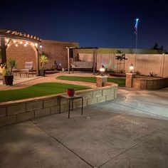 an outdoor patio with lights and seating area in the back yard is lit up at night