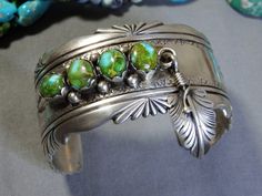 Item Details Pre-Loved Native American silver art. Photos are part of the items condition description. Listing is for bracelet only.TY. Marked "STERLING" & signed by Tom Ahasteen Genuine Sonoran Gold Turquoise. 8-10mm size gemstones. Cuff is 1&3/8" high/wide at front peak, 2" at dangling Feather & 1&3/8" at ends. Cuff measures 5&3/8" end to end on inside. Separate 1&1/2" gap. Currently sized to fit a 6&7/8". Size can be adjusted. Best for wrists sizes 6" to 7". Weighs 78 grams. Thank you for stopping by 😊❗ Silver Feather, Art Photos, Silver Art, Turquoise Sterling Silver, Cuff Bracelet, Native American, Cuff Bracelets, Jewelry Bracelets, Cuff