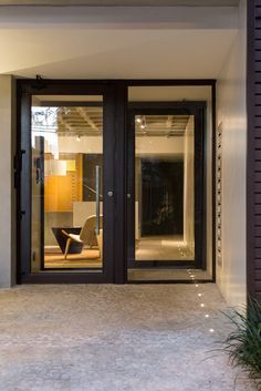 an entrance to a modern home with glass doors