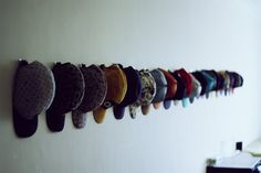 there are many hats hanging on the wall