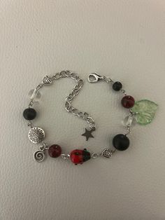 a bracelet with beads and charms on it