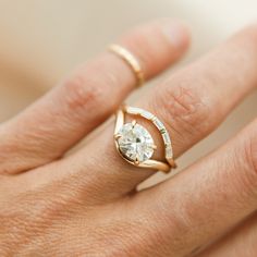 a woman's hand with a diamond ring on it