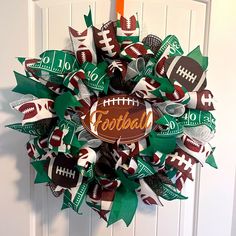 a football wreath on the front door with green, white and red paper streamers