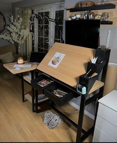 a desk with an easel on it in the middle of a room