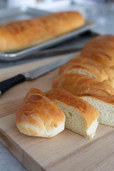 a loaf of bread sitting on top of a wooden cutting board