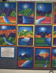 an art project is displayed on the wall in front of a bulletin board with pictures of mountains and rivers