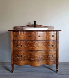 an old wooden dresser with a sink on top