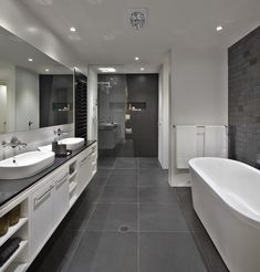 a large bathroom with two sinks and a bathtub