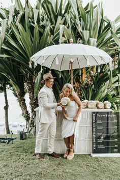 a man and woman standing under an umbrella