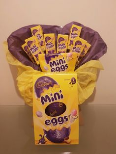 a bouquet of mini eggs sitting on top of a table next to a package of chocolate