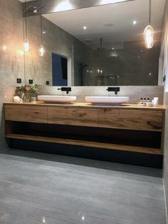 a bathroom with two sinks and a large mirror