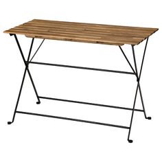 a wooden table sitting on top of a metal frame