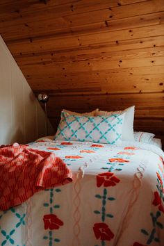 a bed in a room with wooden walls