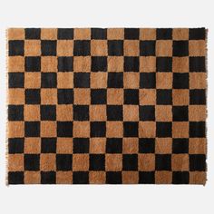 a brown and black rug with squares on it's sides, in the shape of a checkerboard pattern