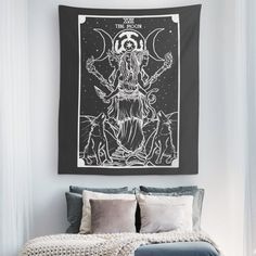 a black and white tapestry hanging above a bed