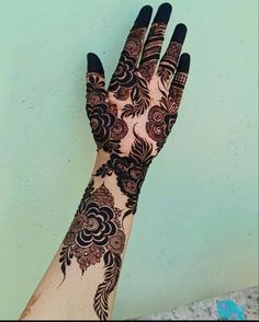 a woman's hand with henna on it