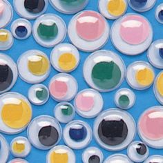 an image of colorful circles and dots on a blue background that looks like it has been made with acrylic paint