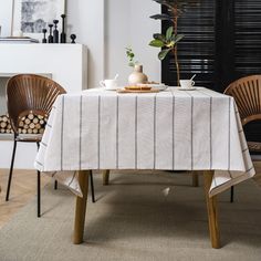 the table is set with two chairs and a potted plant