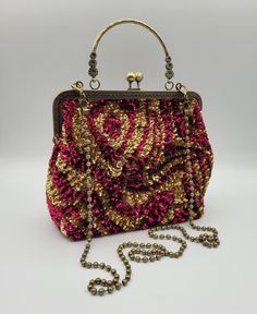 With great pleasure I present this bag, unique piece,entirely made by hands and materials made in Italy. This bag is create with high quality materials such as fabric ,crystals and rhinestones. Each embroidered material is carefully hand sewn. Very glamorous and stylish. Perfect  gift to someone you like.  -------------------------------------------------------------------------- Details: *Metal kiss-lock frame in bronze color long 20 cm (7,8 in) *French vintage sequins. *Lenght of chain 110 cm (43,3 in) *Bag height 20 cm (7,8 in) with handle 28 cm (11,0 in) *Bag width at the bottom 24 cm (9,4 in) *Depth of the bag bottom 10 cm (3,9 in)  The interior of the handbag is lined in black satin fabric with a single pocket enriched with hand embroidered logo, large enough to store cards or lipsti Gift Evening Tote Bag, Top Handle Bags With Detachable Strap As Gift, Evening Tote Shoulder Bag, Handmade Red Party Bag, Handmade Red Bag For Party, Handmade Tote Evening Bag As Gift, Gift Evening Bag Satchel For Mobile Phone, Gift Evening Satchel For Mobile Phone, High-end Bags With Removable Pouch For Gifts