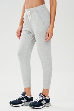 Our best-selling classic cropped sweatpant in ultra luxe fleece, Reena will become your go to piece for every day wear. Pair it with the Warm Up Fleece Pullover and enjoy effortless fit and pure comfort. BEST FOR: Chilling out after running, yoga, CrossFit, barre, Pilates, cycling and spin class. Model is 5'10" and wears a size small. Athleisure Joggers With Elastic Waistband, Cozy Joggers For Jogging, Sportswear Sweats With Elastic Waistband For Lounging, Sporty Pants With Ribbed Waistband For Lounging, Athleisure Ankle-length Joggers For Jogging, Athleisure Joggers With Elastic Waistband For Loungewear, Sporty Loungewear Pants With Ribbed Waistband, Comfy Joggers With Elastic Waistband For Spring, Sporty Sweatpants With Elastic Waistband For Lounging