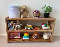 a wooden shelf with toys and books on it in a child's playroom