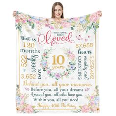 a woman holding up a blanket with the words you have loved in all of us