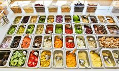 an assortment of different foods are displayed in trays