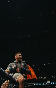 a man standing on top of a wrestling ring