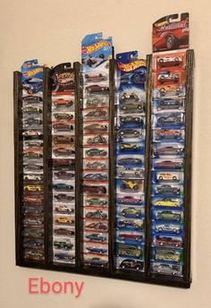 a wall mounted display case filled with hot wheels