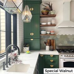 a kitchen with green cabinets and white counter tops